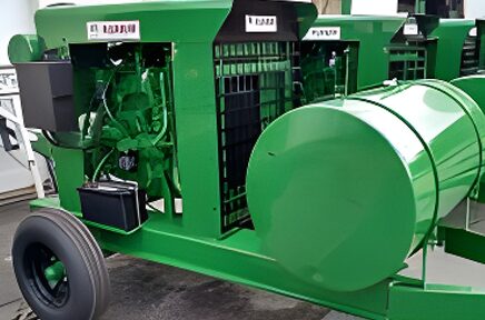 A green tractor with a large engine and trailer.