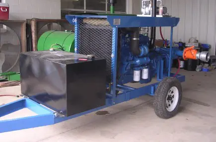 A blue trailer with a large black box on the side.