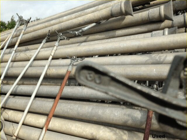 A pile of metal pipes sitting next to each other.