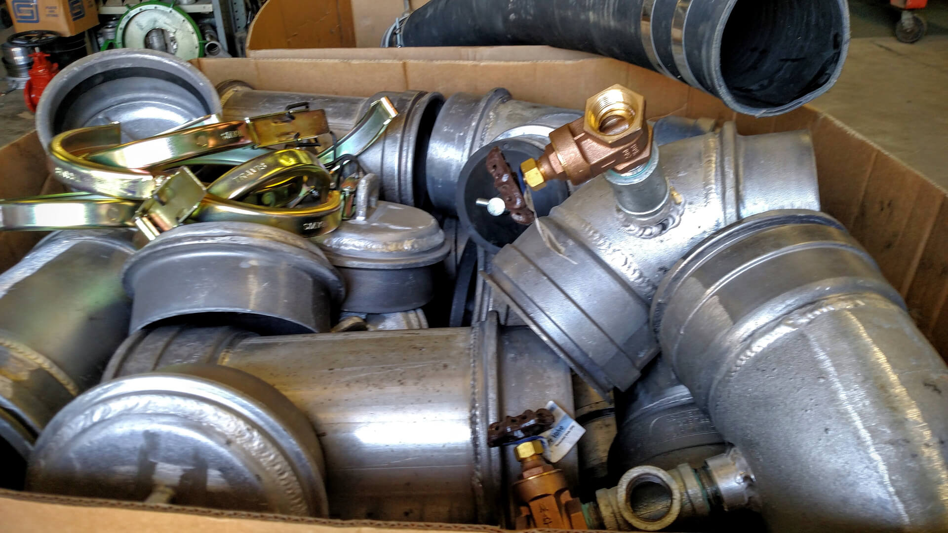 A box of different types of pipes and valves.