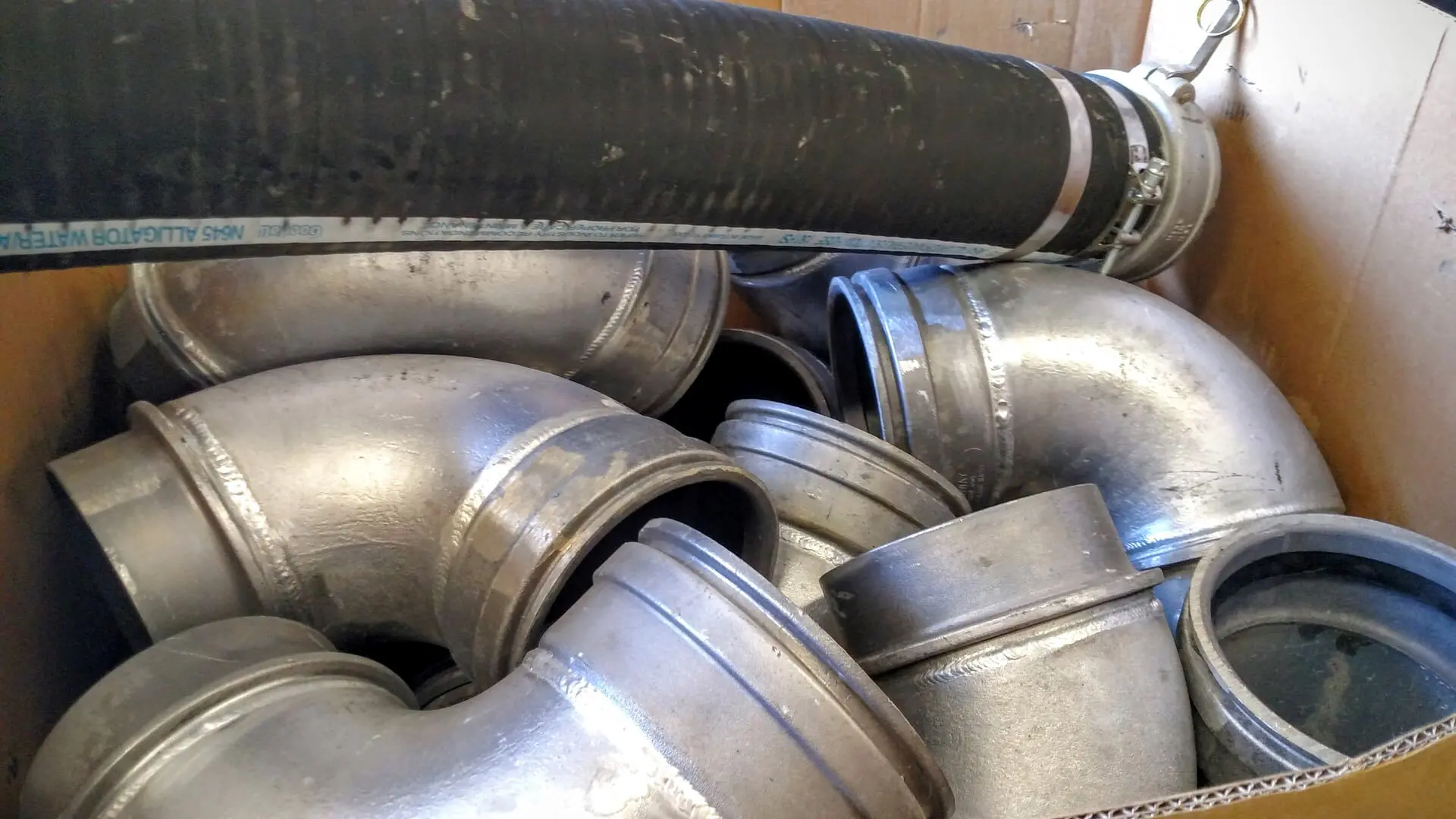 A pile of metal pipes sitting next to each other.