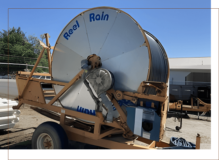 A large white and blue satellite dish on the back of a trailer.